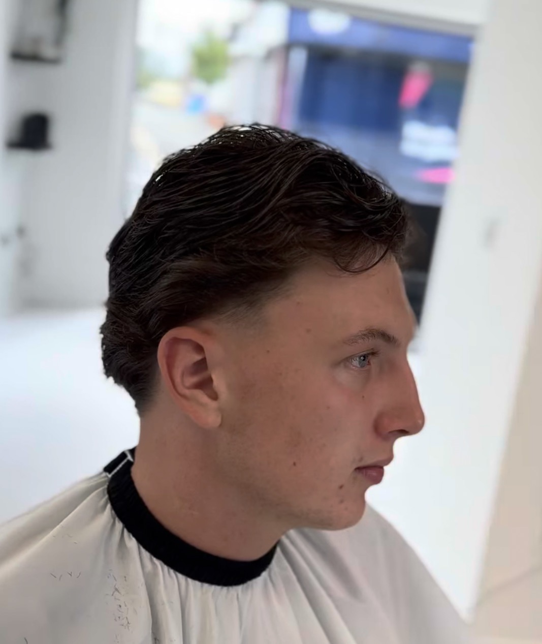 Classic scissor cut on dark wavy hair at our barbers in Leigh town centre