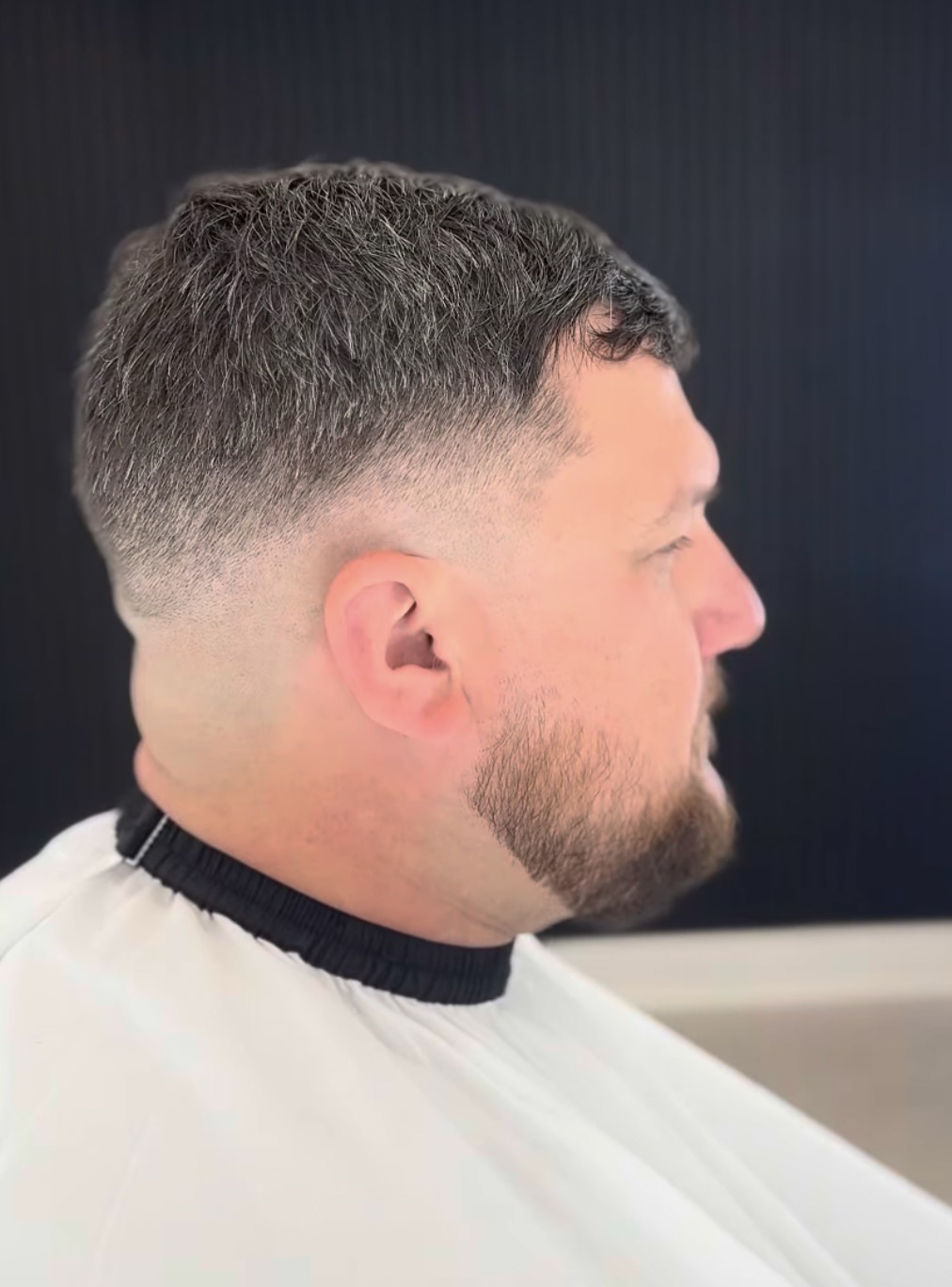 Mid skin fade with a textured crop, cut at Refined Male Grooming barbers in Leigh